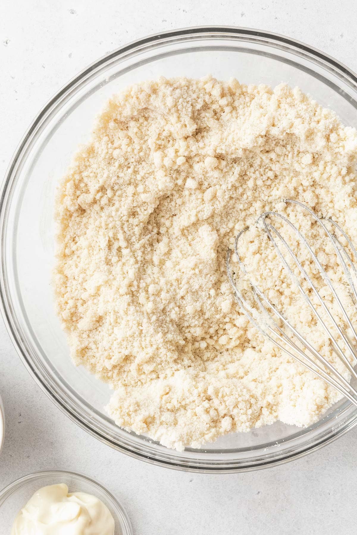 The dry ingredients for gluten-free and dairy-free tres leche cake mixed up in a glass mixing bowl.