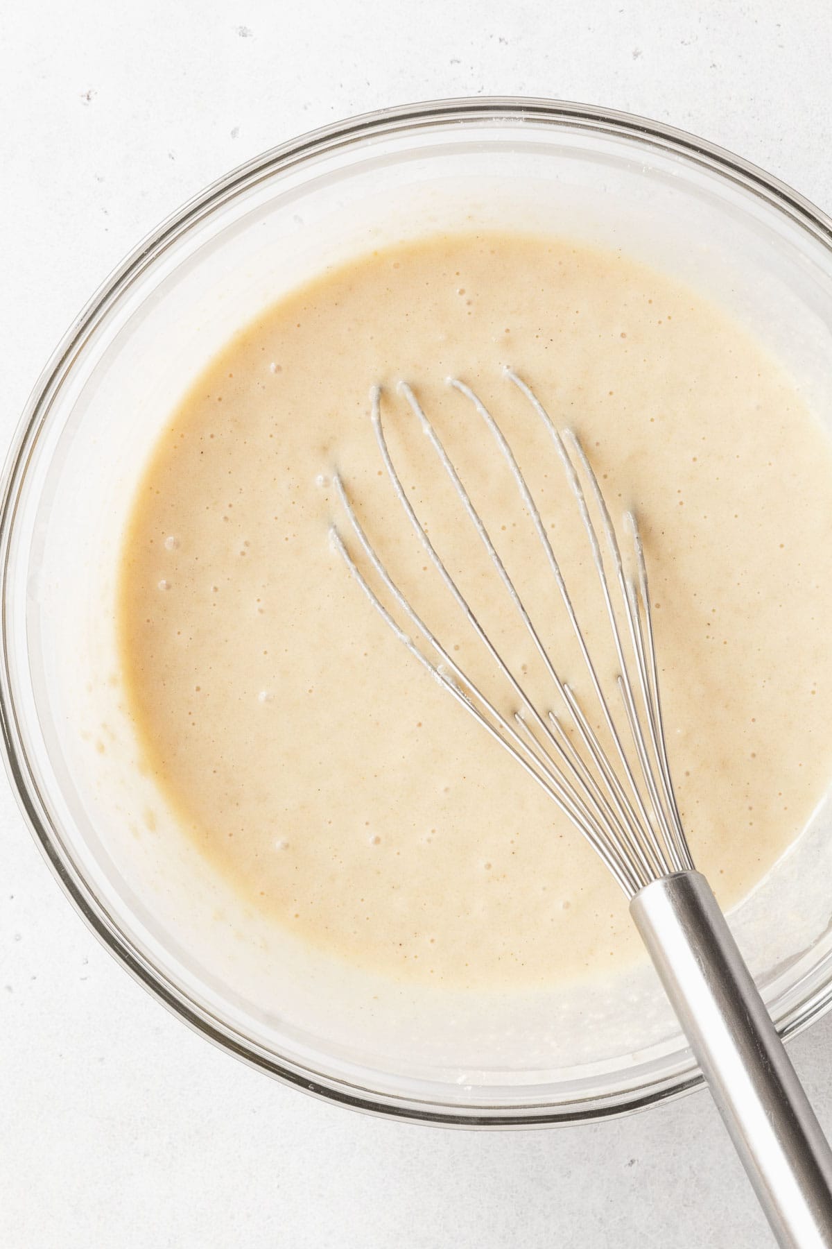 The wet ingredients whisked together in a glass mixing bowl.