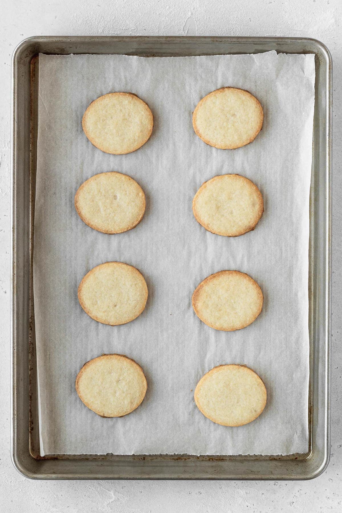 Egg shaped cookies on a baking sheet after they finished baking.