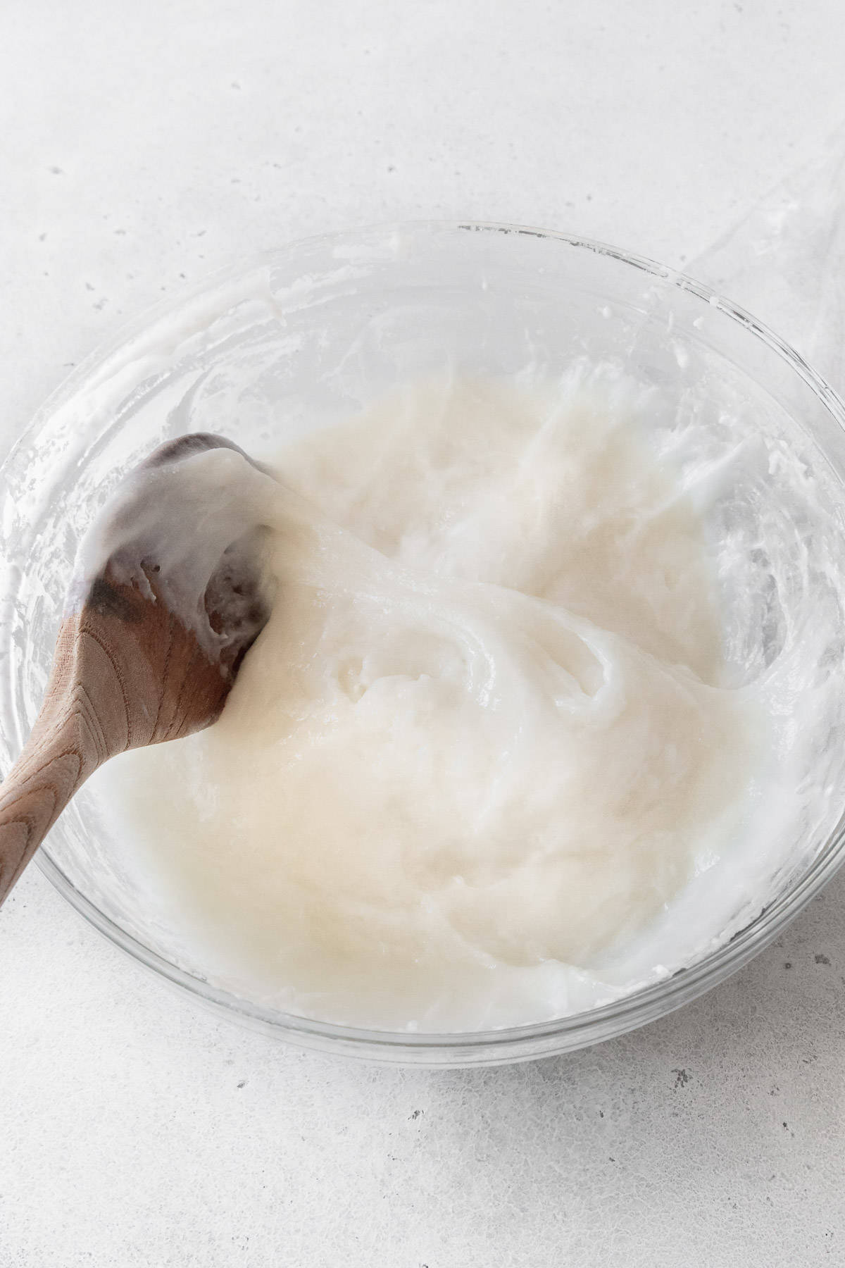 Daifuku mochi dough being mixed with a wooden spoon.