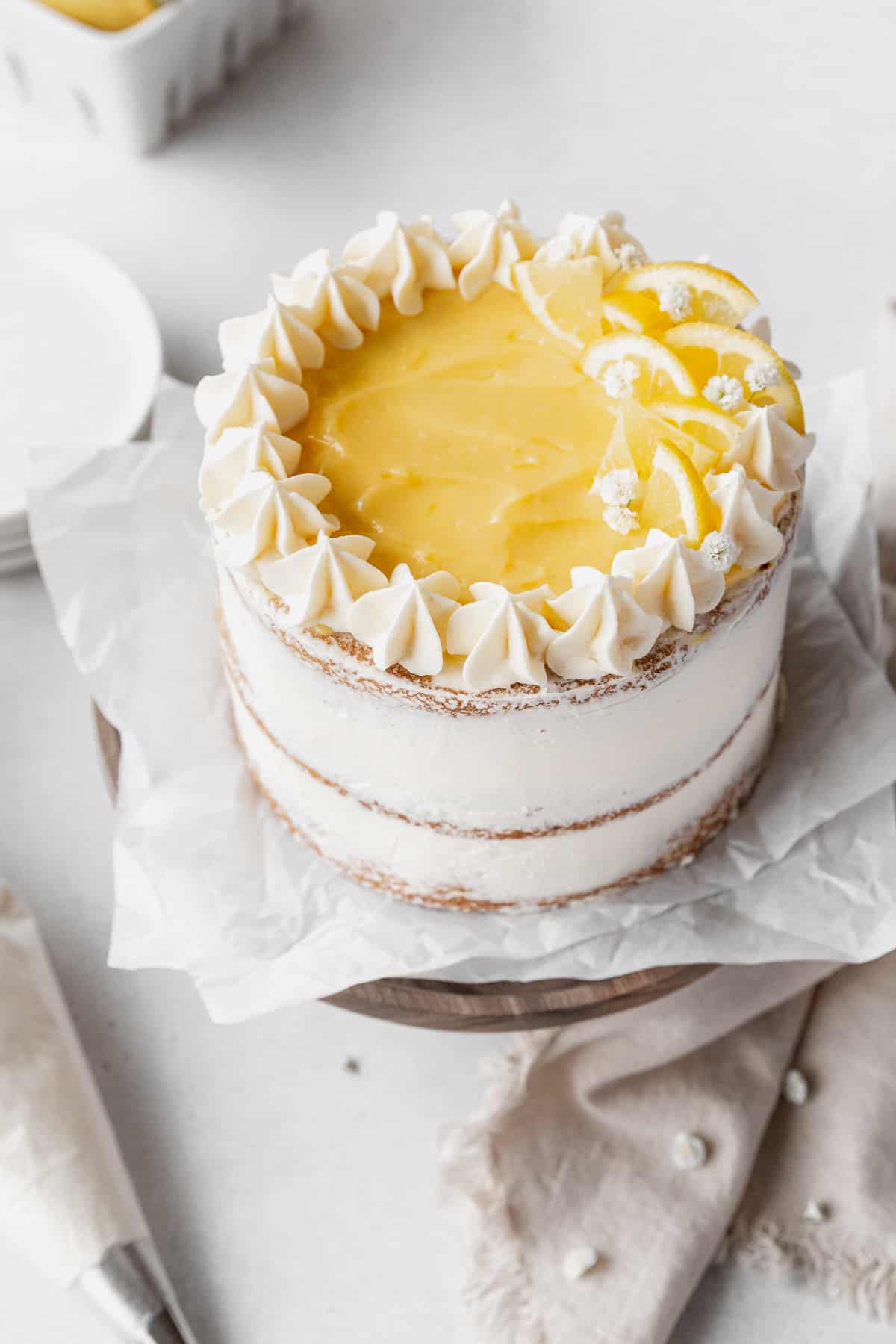 45 degree angle shot showing the top of the decorated dairy-free lemon curd cake.