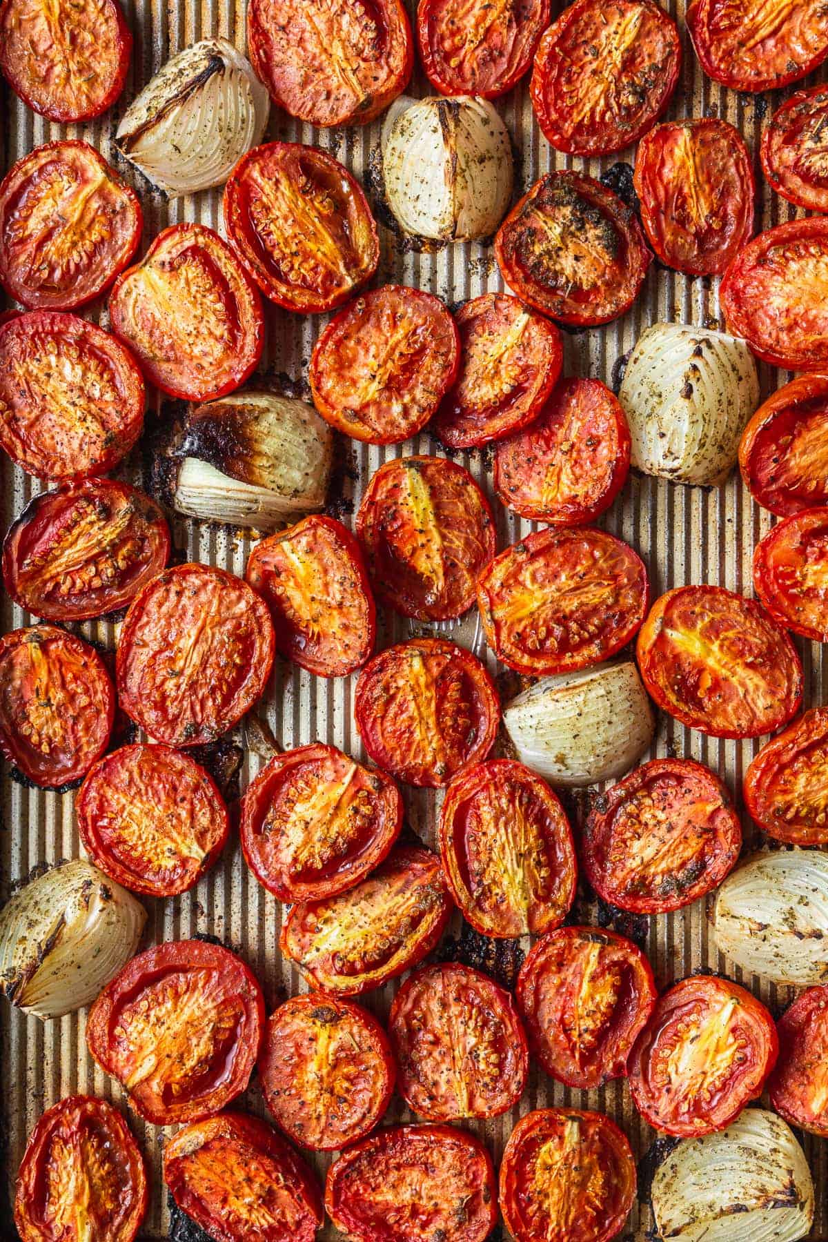 A tray of roasted tomatoes and onions.