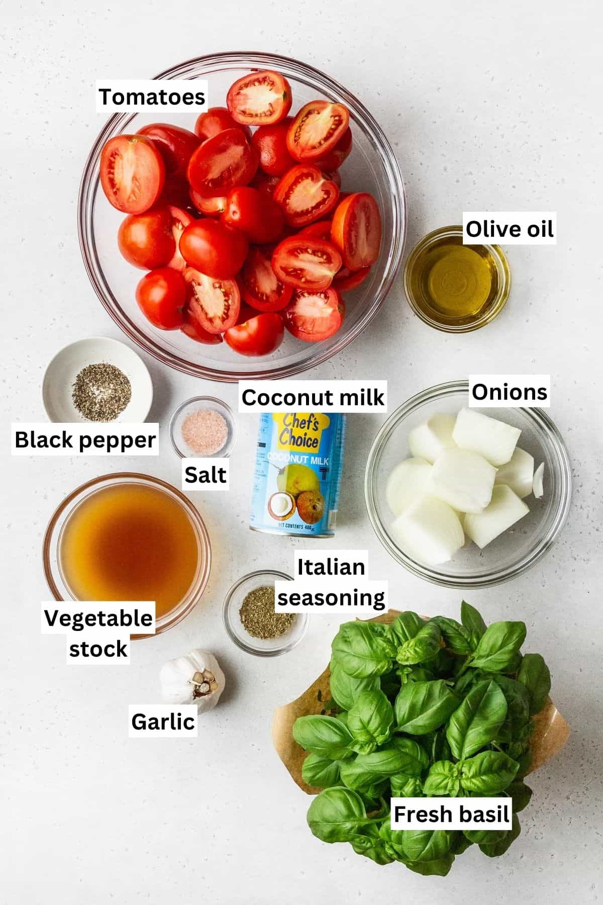 Ingredients for roasted tomato soup measured out into bowls with text overlay.