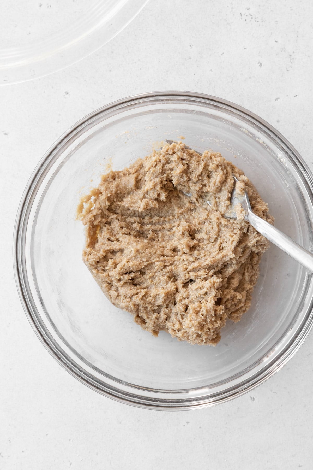 Oat pie crust dough in a glass bowl.