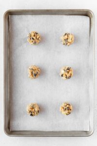 Balls of cookie dough on a baking sheet.