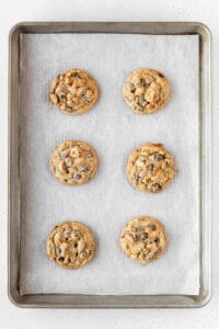 Baked kitchen sink cookies on a baking sheet.