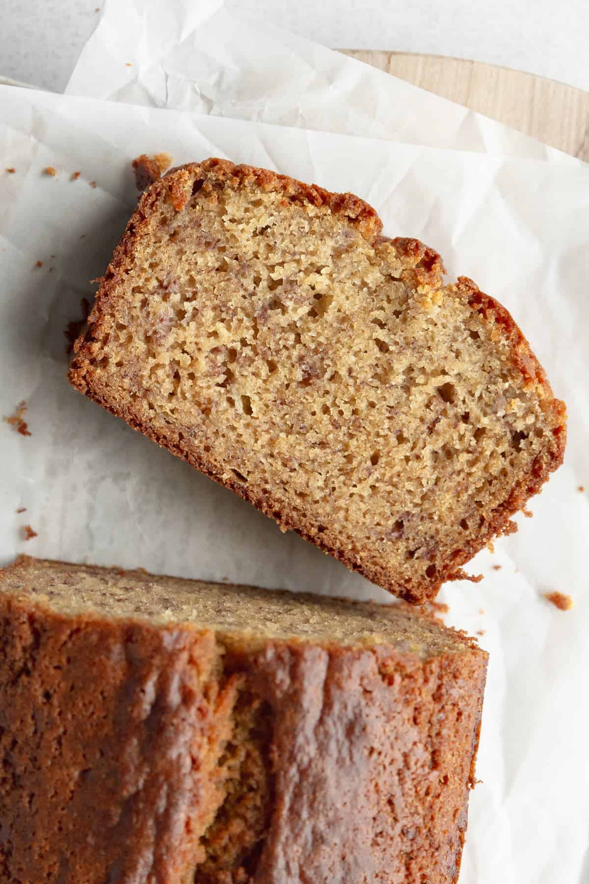 A slice of gf banana bread on parchment paper.