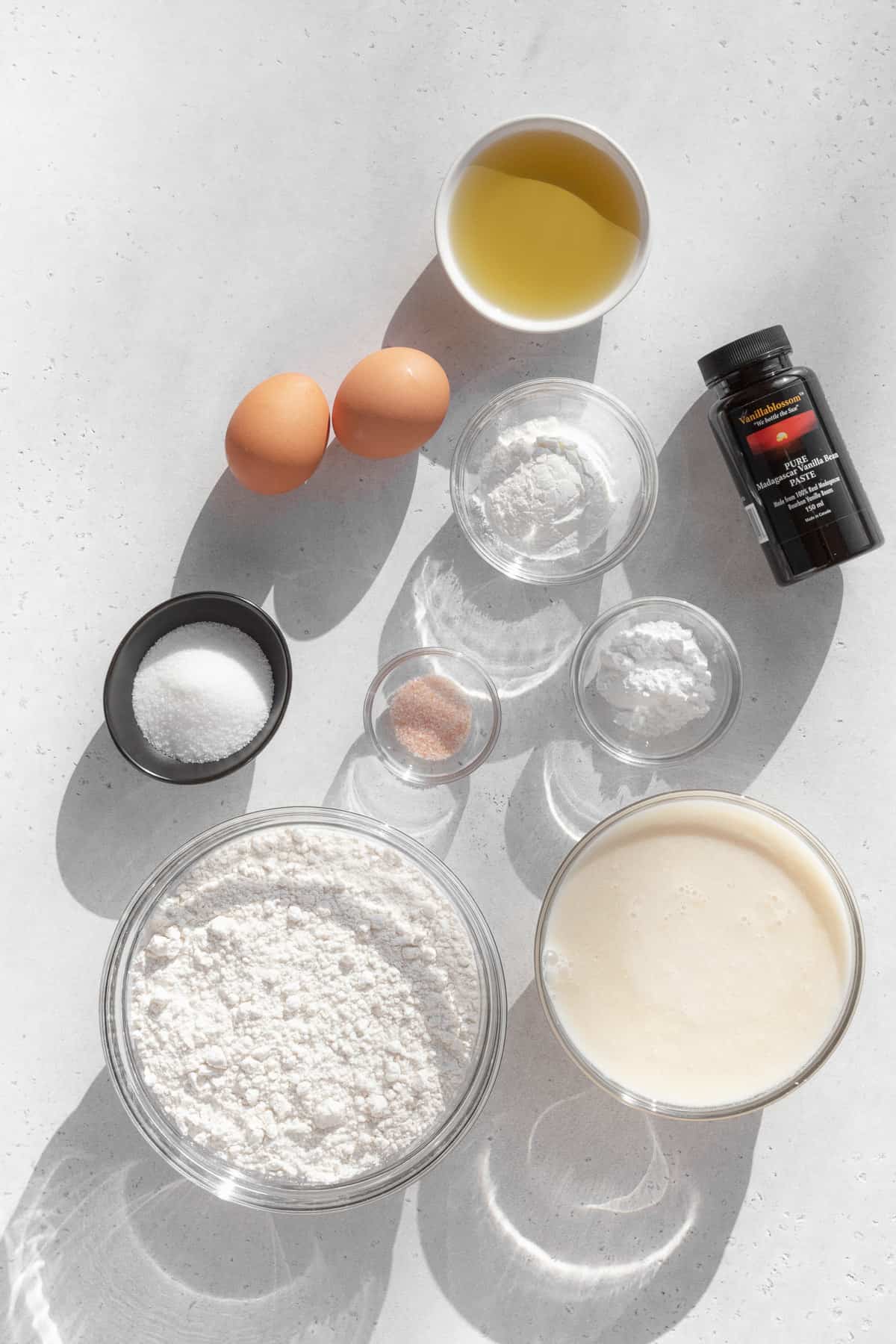 Ingredients to make gluten free waffles measured out into bowls.