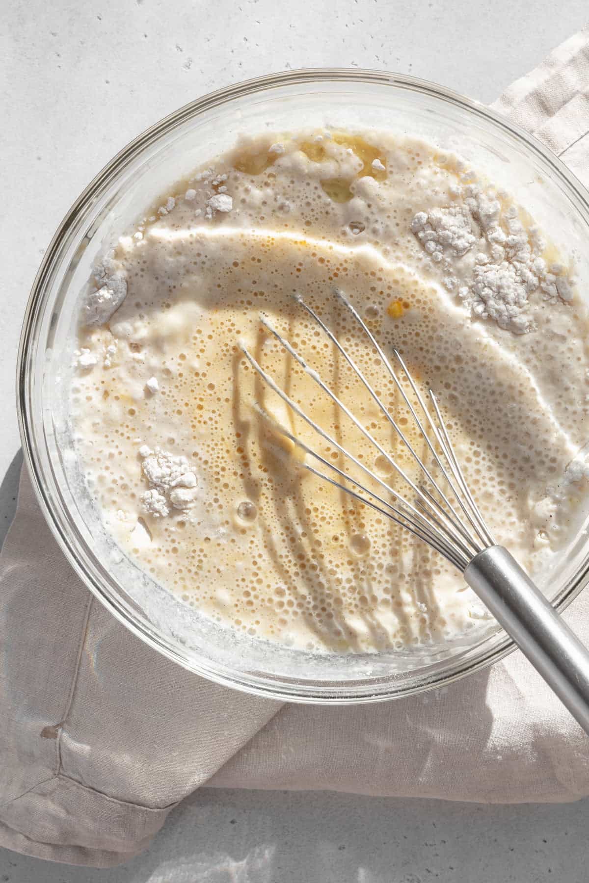 GF waffle batter being whisked together in a glass bowl.