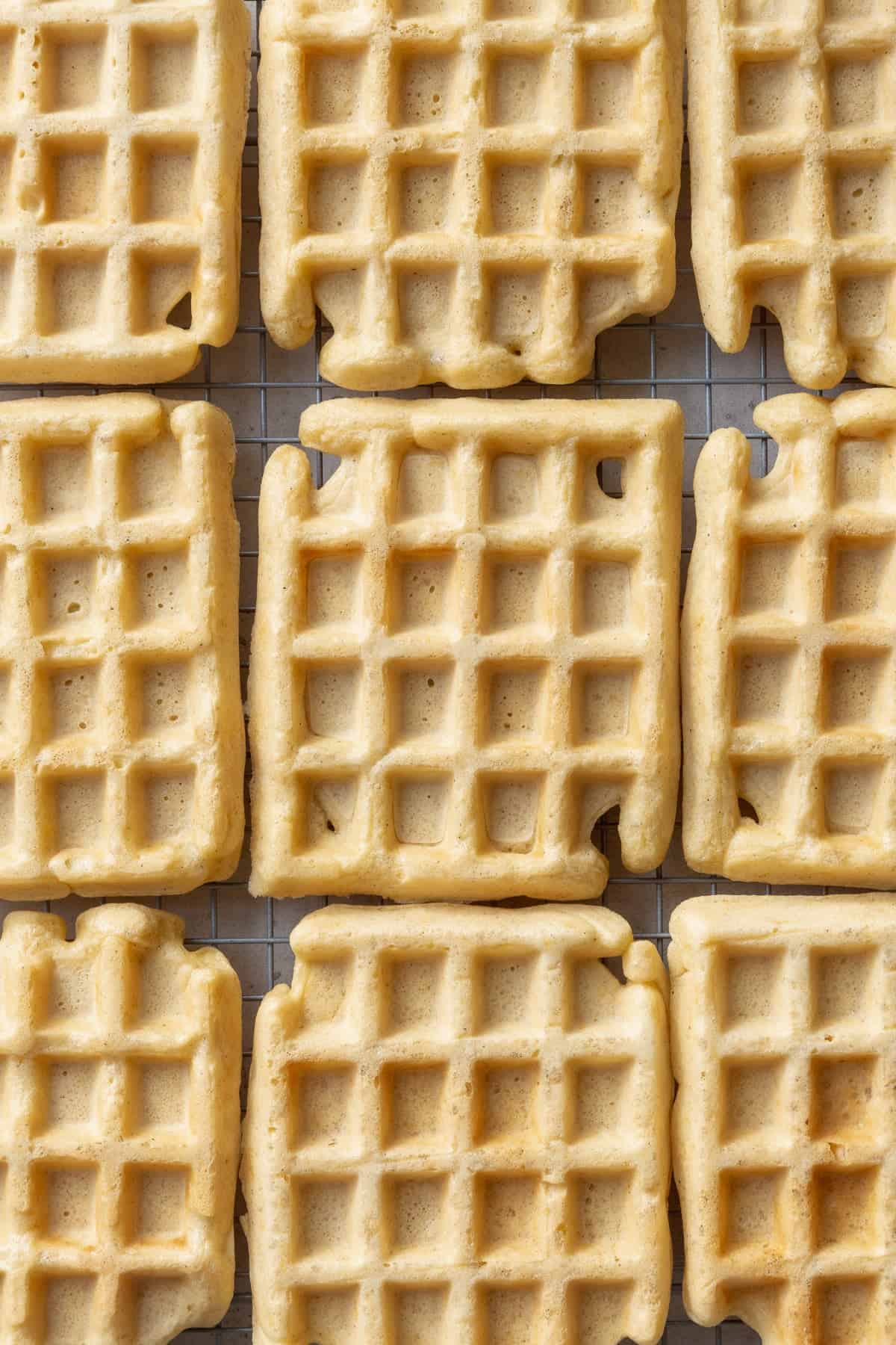 Waffles cooling on a wire rack.