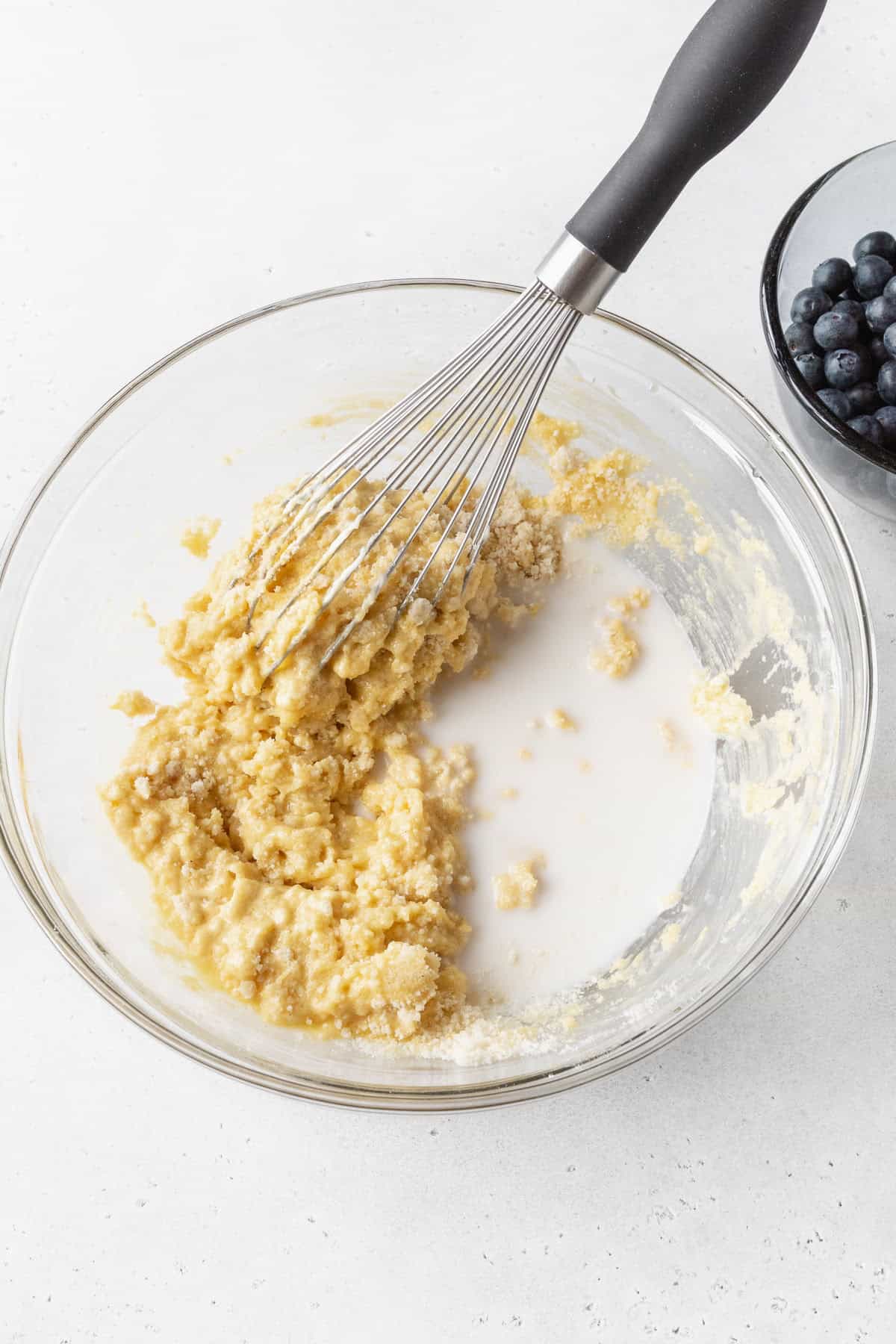 A whisk mixing coffee cake batter.