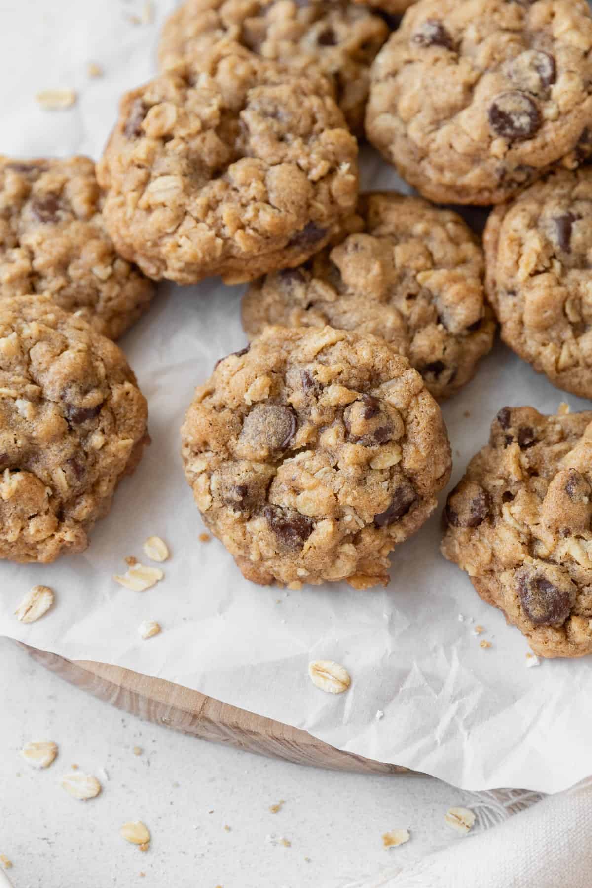 Gluten free oatmeal cookies with chocolate chips on a piece of parchment.