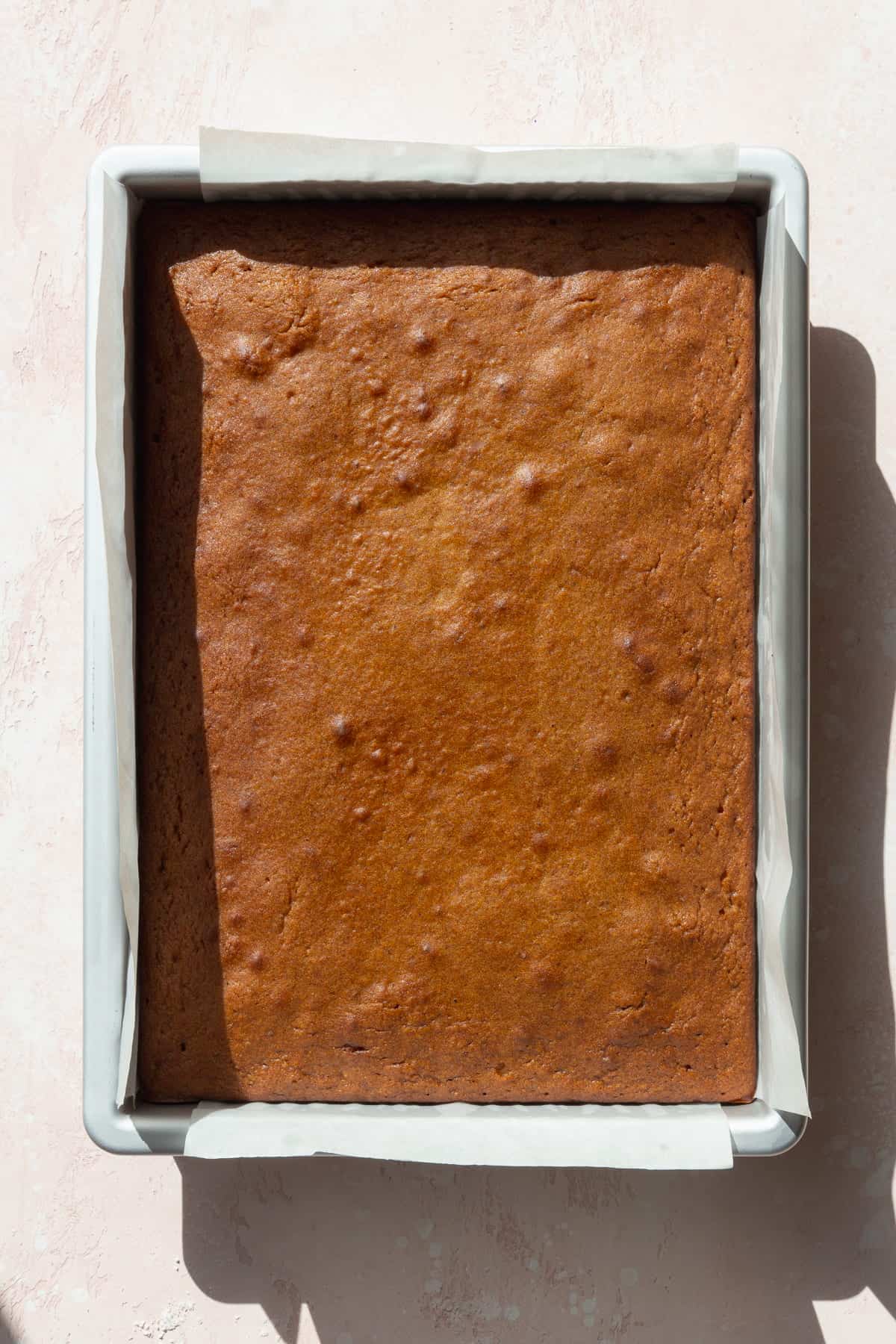 Baked pumpkin bar in a baking pan.