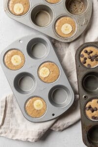 Banana muffin batter in a muffin pan.