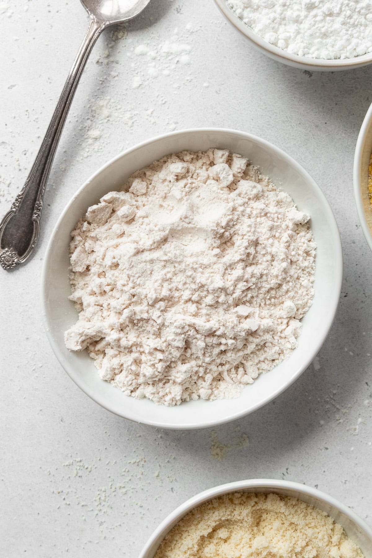 Gluten-free all-purpose flour in a bowl with more bowls around it.