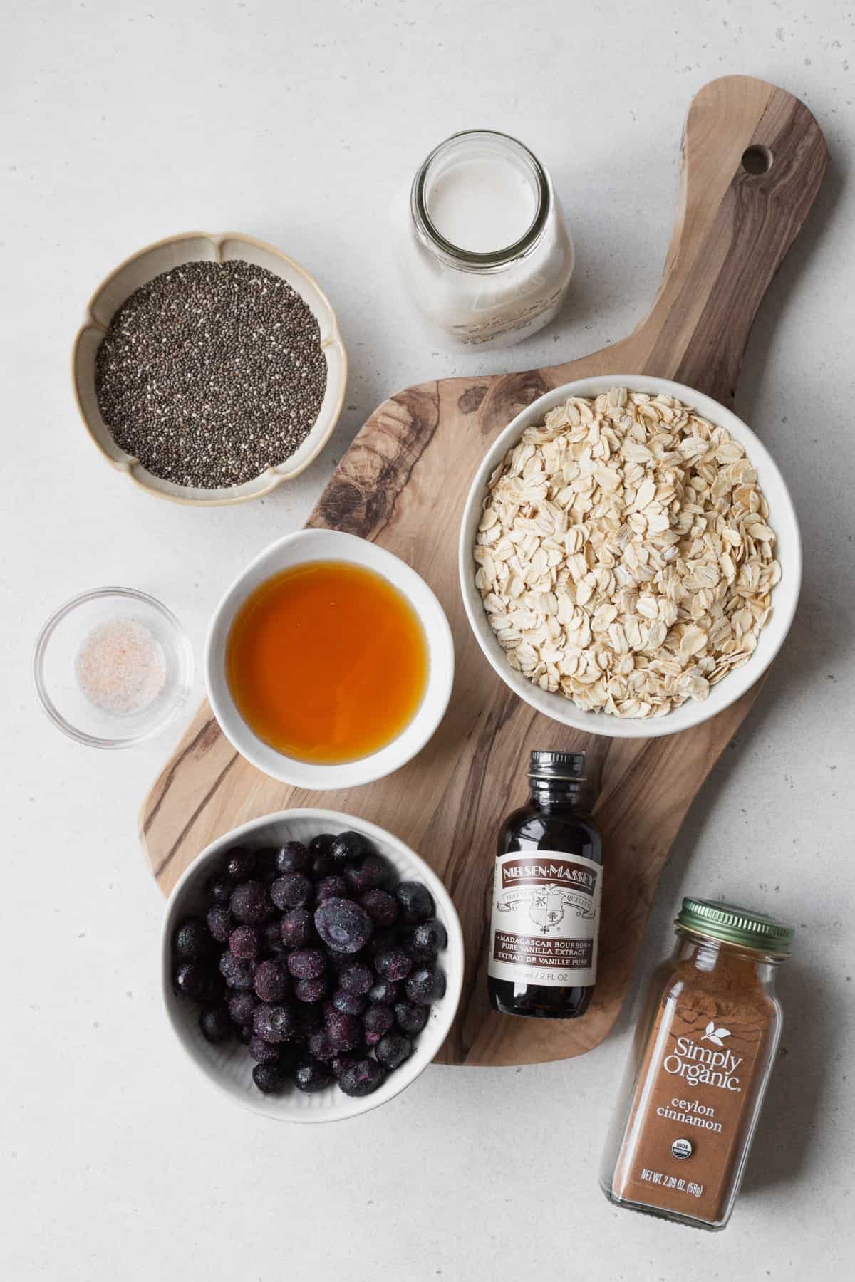 Ingredients to make blueberry overnight oats measured out into bowls.
