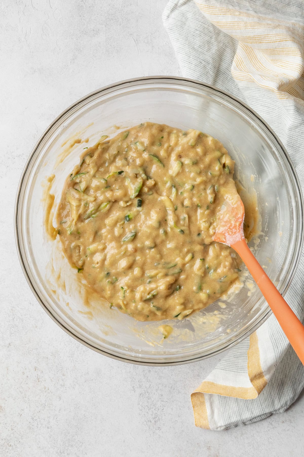 Zucchini bread batter in a glass bowl.