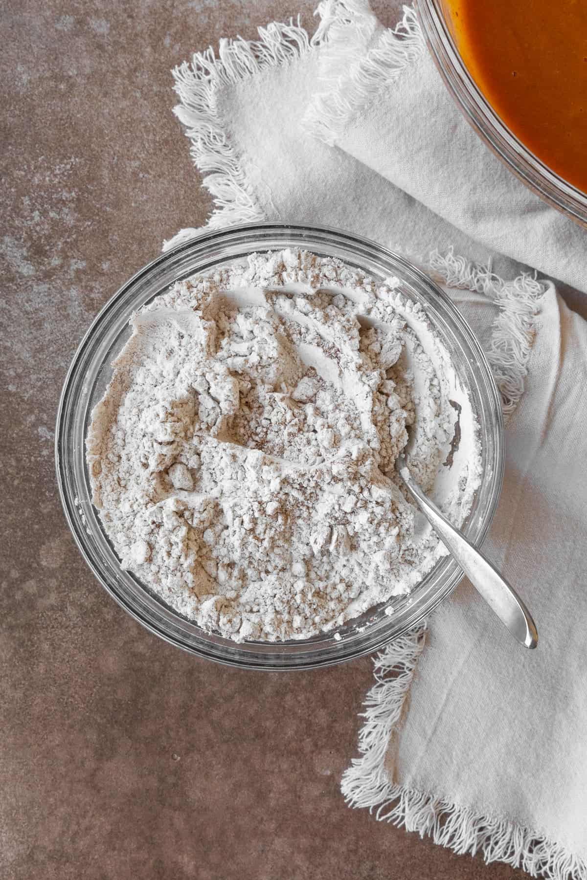 A bowl of flour and spices in a glass bowl.