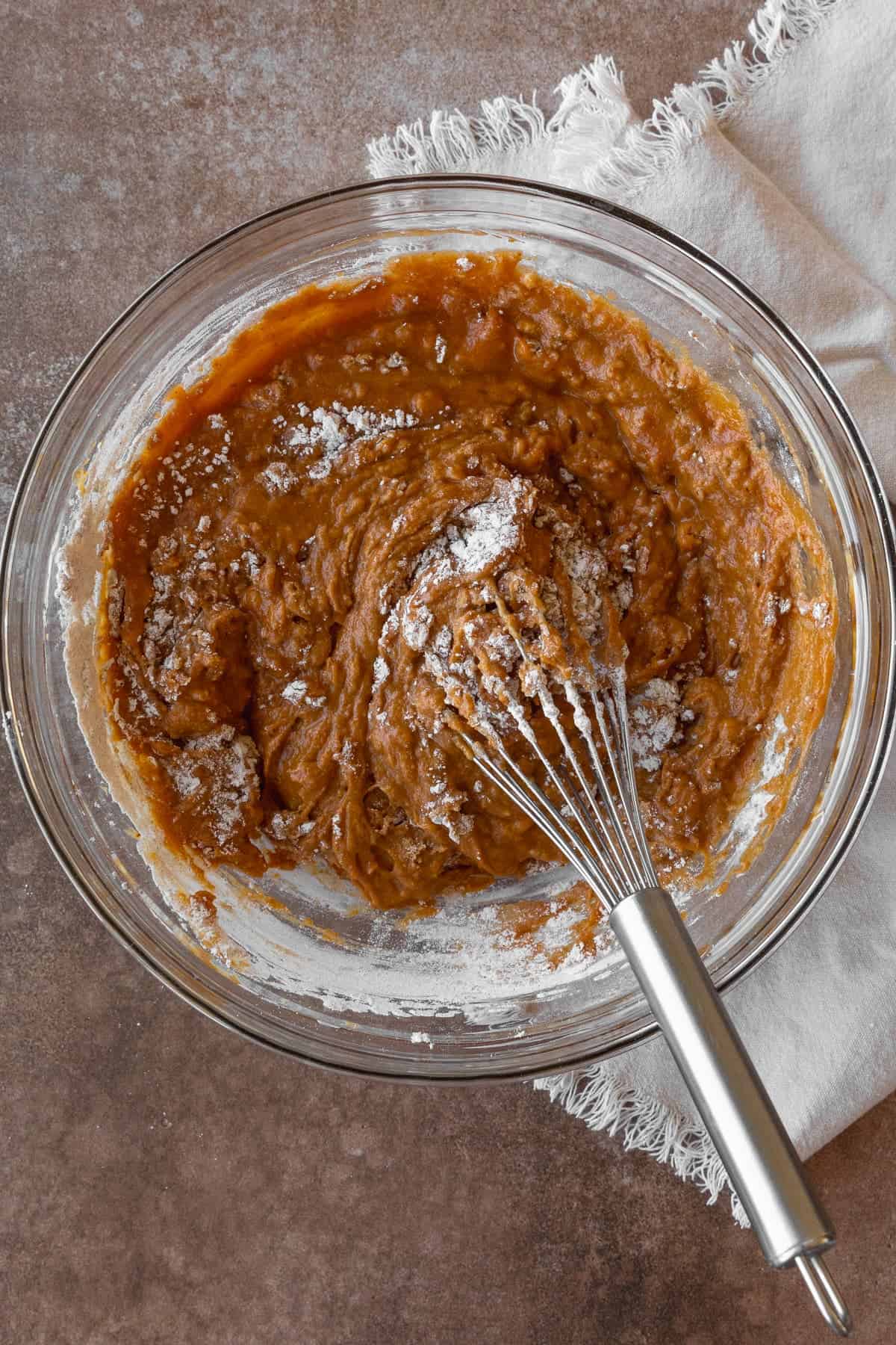 Whisking together gluten free pumpkin muffin batter.